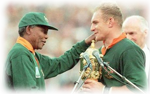 President Nelson Mandela hands the William Webb Ellis Cup over to Captian Francios Pienaar after South Africa won the 1995 Rugby World Cup